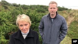 Patricia Rogers, left, and Jeff Bryner pose during an interview on Wednesday, Jan. 8, 2020, with the Facebook lot behind them, in Tierra Del Mar, Oregon.(AP Photo/Andrew Selsky) 