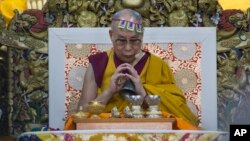 FILE - Tibetan spiritual leader the Dalai Lama prays at Tsuglakhang temple in Dharmsala, India, May 27, 2017.