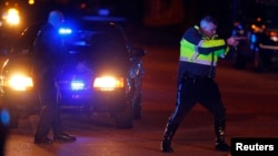 Police officers keep a man on the ground in Watertown, Massachusetts April 19, 2013 following the shooting of a police officer at the Massachusetts Institute of Technology (MIT).