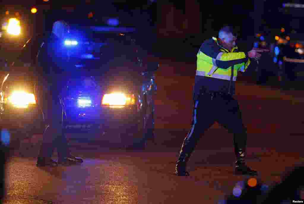 Police officers keep a man on the ground in Watertown, Massachusetts April 19, 2013 following the shooting of a police officer at the Massachusetts Institute of Technology (MIT).