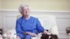 First lady Barbara Bush poses with her dog Millie in 1990. 