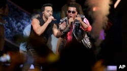 Singers Luis Fonsi, left and Daddy Yankee perform during the Latin Billboard Awards, April 27, 2017 in Coral Gables, Fla.