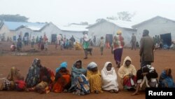 FILE - Congolese families sit at the Kyangwali refugee settlement camp, Uganda, March 19, 2018. 