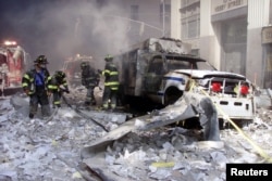 A police car sits amid rubble near the base of the destroyed World Trade Center towers in New York on September 11, 2001. Exposure to toxic dust led to a host of respiratory diseases and cancer in first responders.