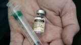 FILE - A doctor holds a vial of the human papillomavirus vaccine Gardasil in his Chicago, Illinois,, office. The southwestern African nation of Namibia is struggling with its rollout of the human papillomavirus vaccine.