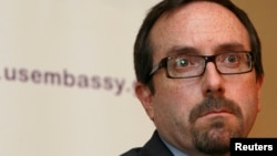 John Bass, shown while serving as U.S. ambassador to Georgia on June 28, 2012, attends a news conference in Tbilisi. Bass — the current ambassador to Turkey — is upset by Ankara's arrest of U.S. employee Metin Topuz.