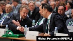 Bosnia and Herzegovina - Sarajevo - A candidate for president of the party Democratic Action Bakir Izetbegovic shakes hands with Asim Sarajlic during the 6th Congress of the Party of Democratic Action (SDA) in Sarajevo. 26May2015.