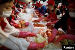 People take part in the Seoul Kimchi Festival in central Seoul, South Korea, Nov. 3, 2017.