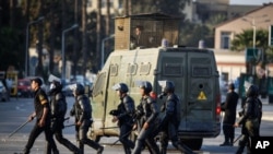 Egyptian riot police move to disperse students and supporters of the country's ousted president after they rallied outside a Cairo university, Thursday, Nov. 28, 2013.