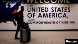 FILE - An international passenger arrives at Washington Dulles International Airport in Virginia. 