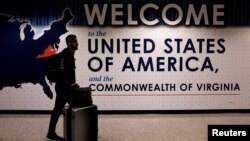 FILE - An international passenger arrives at Washington Dulles International Airport in Virginia. 