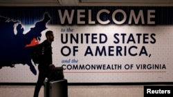 FILE - An international passenger arrives at Washington Dulles International Airport in Virginia.