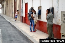Cubans use payphones on Consulado side street across from Havana’s Capitol building.
