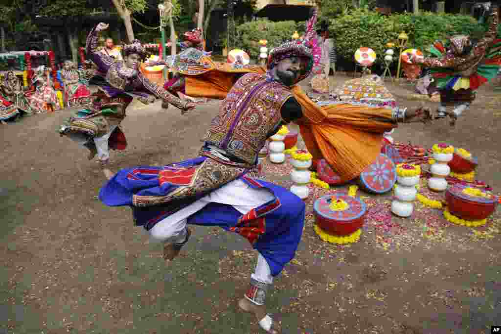 Indians wearing traditional attire practice Garba, a dance of Gujarat state, ahead of Navratri festival in Ahmadabad.
