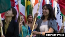 FILE - International students carry their national flags at the University of Missouri in Columbia, Missouri.