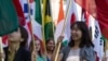 FILE - International students carry their national flags at the University of Missouri in Columbia, Mo.