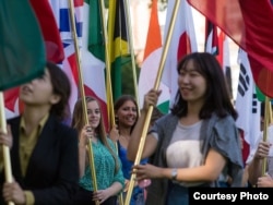 International students carry their national flags at the University of Missouri in Columbia, Missouri.