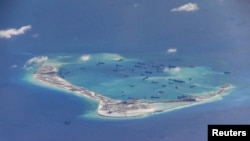 FILE - Chinese dredging vessels are purportedly seen in the waters around Mischief Reef in the disputed Spratly Islands in the South China Sea, May 21, 2015.