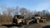 Destroyed Ukrainian army vehicles lie on the side of the road towards Debaltseve near the town of Artemivsk, Ukraine, Feb. 13, 2015. 