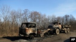 Destroyed Ukrainian army vehicles lie on the side of the road towards Debaltseve near the town of Artemivsk, Ukraine, Feb. 13, 2015. 