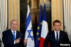 French President Emmanuel Macron and Israeli Prime Minister Benjamin Netanyahu attend a joint news conference at the Elysee Palace in Paris, Dec. 10, 2017.