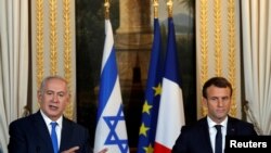 French President Emmanuel Macron and Israeli Prime Minister Benjamin Netanyahu attend a joint news conference at the Elysee Palace in Paris, Dec. 10, 2017.