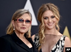 FILE - Carrie Fisher and her daughter, Billie Catherine Lourd, arrive for an awards ceremony at the Dolby Ballroom in Los Angeles, Nov. 14, 2015.
