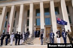 Defense Secretary Lloyd Austin stands with Australian Minister of Defense Peter Dutton during a ceremony at the Pentagon in Washington, Wednesday, Sept. 15, 2021.