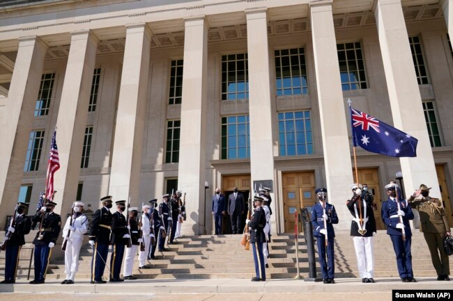 Defense Secretary Lloyd Austin stands with Australian Minister of Defense Peter Dutton during a ceremony at the Pentagon in Washington, Wednesday, Sept. 15, 2021.