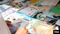 A high school student scans for Khmer novels in a book store, Phnom Penh, Cambodia, March 11, 2017. (Khan Sokummono/VOA Khmer)