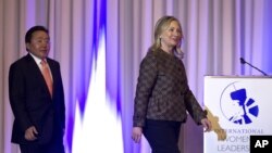 U.S. Secretary of State Hillary Rodham Clinton, right, and Mongolian President Elbegdorj Tsakhia arrive at the International Women's Leadership Forum held inside Parliament in Ulaanbaatar, Mongolia, July 9, 2012. 