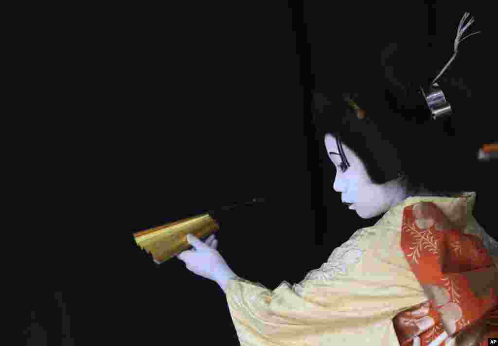 An elementary school boy acting as an young woman performs during a show of an amateur children kabuki theatrical company in Tokyo, Japan.