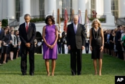 President Barack Obama, first lady Michelle Obama, Vice President Joe Biden, and Jill Biden bow their heads for a moment of silence on the South Lawn of the White House in Washington, Sept. 11, 2013.