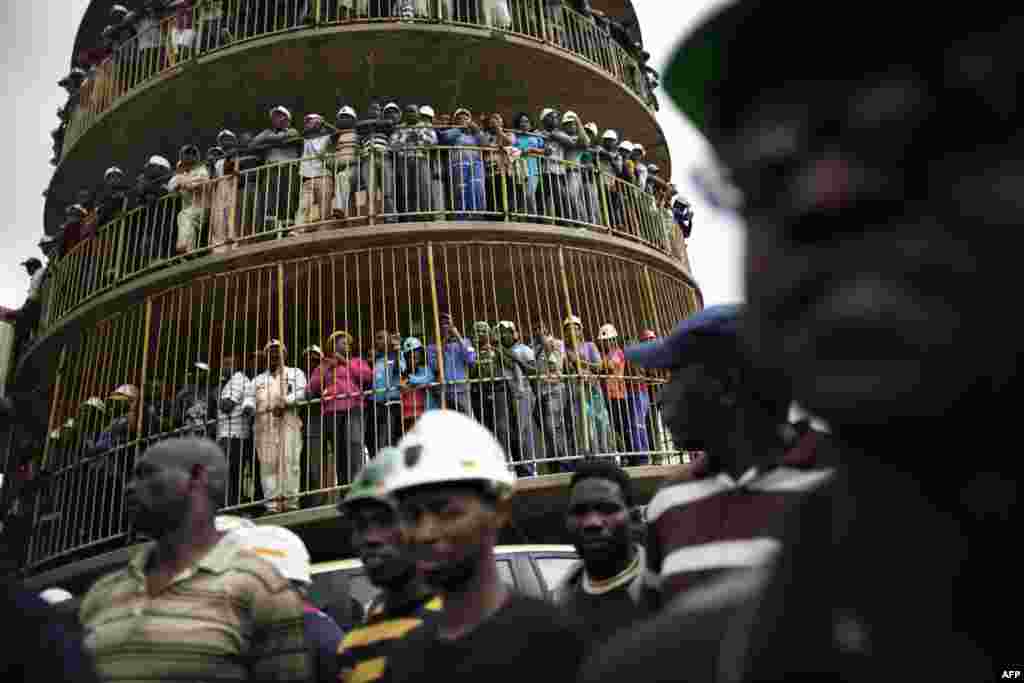 Miners of Harmony Gold&#39;s Doornkop mine gather to mourn their colleagues who died in a mining accident in Doornkop, southwest of Johannesburg. Eight mineworkers trapped in an underground fire were found dead after overnight searches in one of South Africa&#39;s worst mine accidents since 2009. 