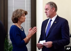 FILE - Sen. Lisa Murkowski, R-Alaska, talks with Interior Secretary Ryan Zinke in her office on Capitol Hill in Washington. Alaska's pro-development congressional delegation is asking the Trump administration to back off from offering nearly all lands off its coast for oil drilling.
