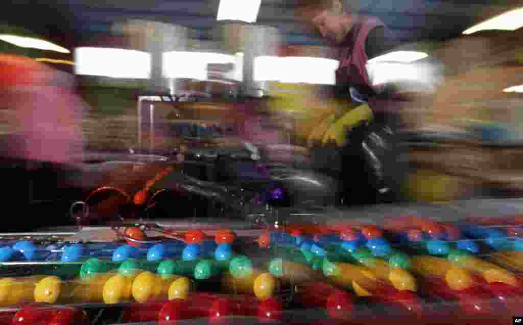 An employee of an Easter egg dyeing company controls colored, cooked eggs in Thannhausen near Augsburg, southern Germany. Up to 200,000 eggs are being dyed in the company daily pre-Easter.