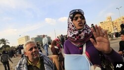 A female Egyptian protester wearing a sling to support her arm, describes how she was hit by Egyptian army soldiers, during a demonstration against the military regime, at Tahrir Square in central Cairo, December 21, 2011.