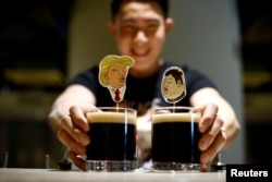 A bartender presents a pair of Donald Trump and Kim Jong Un cocktails called The Bromance at Hopheads Craft Beer Bar and Bistro in Singapore, June 8, 2018.