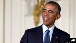 President Barack Obama speaks during a ceremony before presenting the Medal of Honor to retired Army Command Sgt. Maj. Bennie G. Adkins and posthumously to Army Spc. Donald P. Sloat in the East Room of the White House in Washington, Sept. 15, 2014. (AP Ph