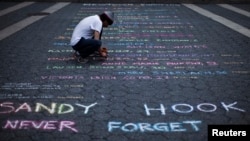 In New York City, a street artist creates a memorial for the 26 children and educators killed in the Sandy Hook Elementary School massacre. (June 14, 2013) 