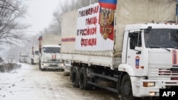 A Russian convoy transporting what Moscow said is humanitarian goods for pro-Russian separatists enters the eastern rebel-held city of Donetsk, Nov. 30, 2014.