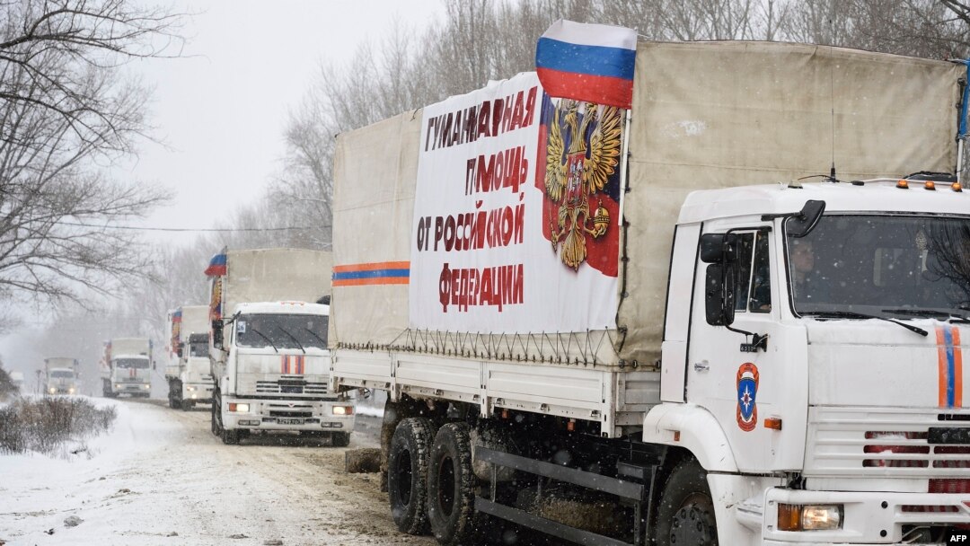 A Russian convoy of trucks is seen entering the city of Donetsk, eastern Ukraine, Nov. 30, 2014. The lettering on the trucks reads "Humanitarian aid from the Russian Federation."
