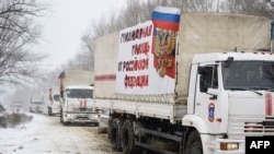 A Russian convoy of trucks is seen entering the city of Donetsk, eastern Ukraine, Nov. 30, 2014. The lettering on the trucks reads "Humanitarian aid from the Russian Federation."
