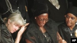 FILE - Wife of the late Zambian President Christine Kaseba Sata, center, is comforted at the funeral of her husband, Michael Sata, in Lusaka, Nov. 11, 2014. 