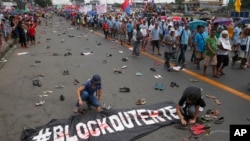 Protesters scatter pairs of slippers and shoes to symbolize victims killings in the so-called war on drugs of President Rodrigo Duterte, Manila, Philippines.