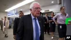 FILE - Democratic presidential candidate Sen. Bernie Sanders, I-Vt. heads to the Senate chamber on Capitol Hill in Washington, June 26, 2016. Sanders supporters failed to include language opposing the Trans-Pacific Partnership trade deal in a draft of the