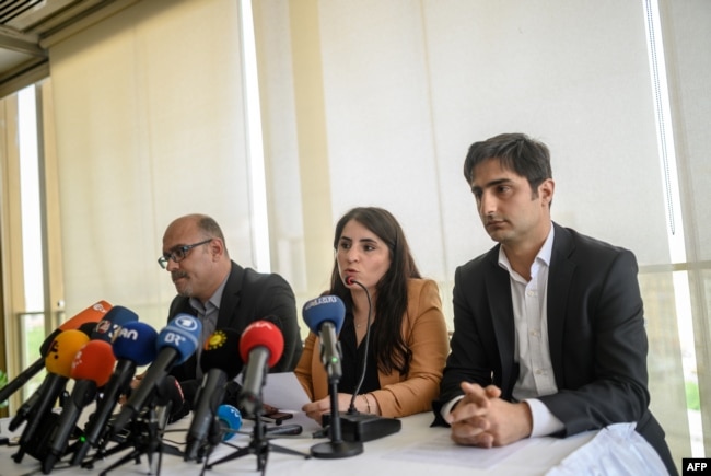 FILE - Turkish Kurd leader Abdullah Ocalan's lawyers, left to right, Faik Ozgur Erol, Newroz Uysal and Rezan Sarica prepare to read Ocalan's message during a press conference in Istanbul, May 6, 2019.