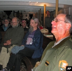 Park ranger Peter Kasin (right) leads a sea chantey sing-along aboard the 1886 sailing ship, The Balclutha.