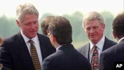 President Bill Clinton, left, and Georgia Gov. Zell Miller, right, are greeted as they arrive at the Mercer County Airport in Ewinging, New Jersey, June 4, 1996. Clinton was in New Jersey to address the 249th Commencement at Princeton University.