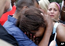 Diamond Reynolds, the girlfriend of Philando Castile is consoled by a minister outside the governor's residence in St. Paul, Minn., on Thursday, July 7, 2016.